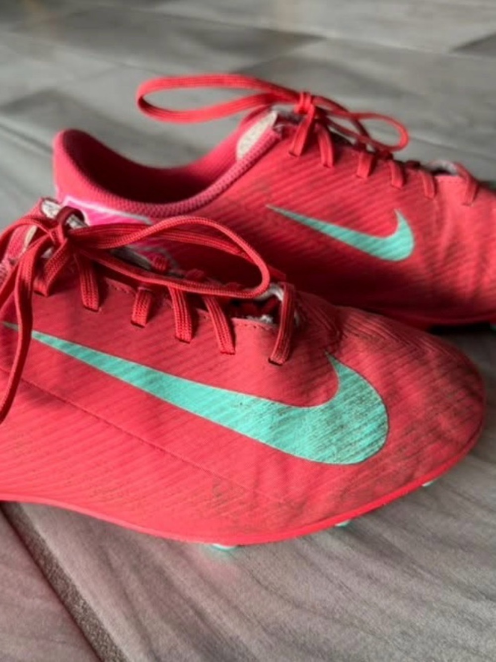 Nike Women’s Coral Red Athletic Cleats with Teal Swoosh